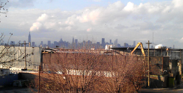 Looking west towards Manhattan from the Scott Ave. pedestrian overpass. Allocco's facility can be seen in the foreground.
